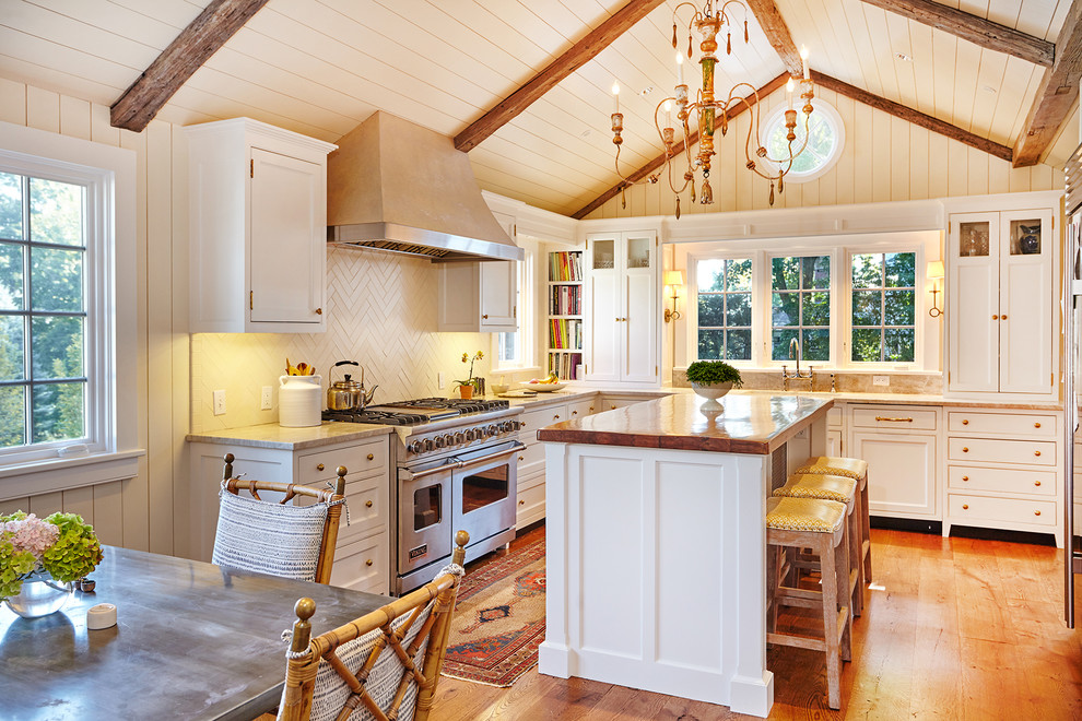 Inspiration for a country u-shaped eat-in kitchen in New York with an undermount sink, beaded inset cabinets, white cabinets, marble benchtops, white splashback, ceramic splashback, panelled appliances, with island and medium hardwood floors.