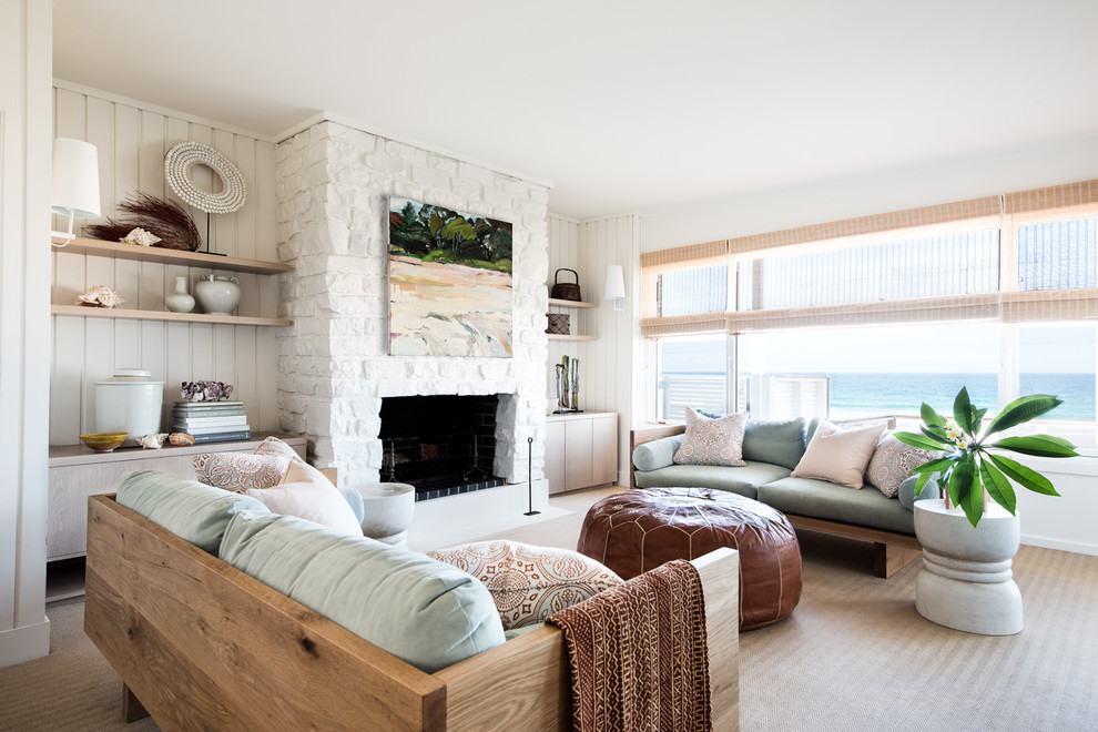Inspiration for a beach style formal enclosed living room in Sydney with white walls, carpet, a standard fireplace, a stone fireplace surround and beige floor.