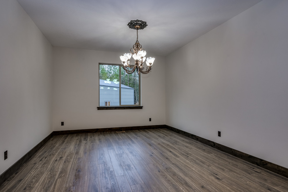 Mountain style laminate floor and brown floor dining room photo