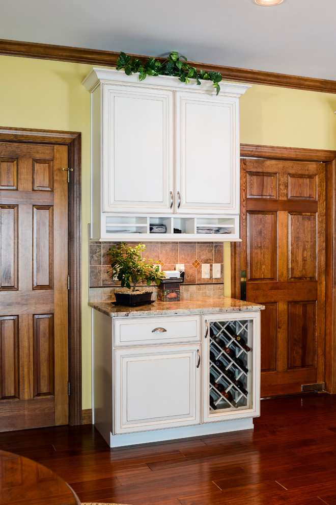 Inspiration for a large transitional u-shaped medium tone wood floor eat-in kitchen remodel with beaded inset cabinets, medium tone wood cabinets, granite countertops, beige backsplash, mosaic tile backsplash, stainless steel appliances and an island