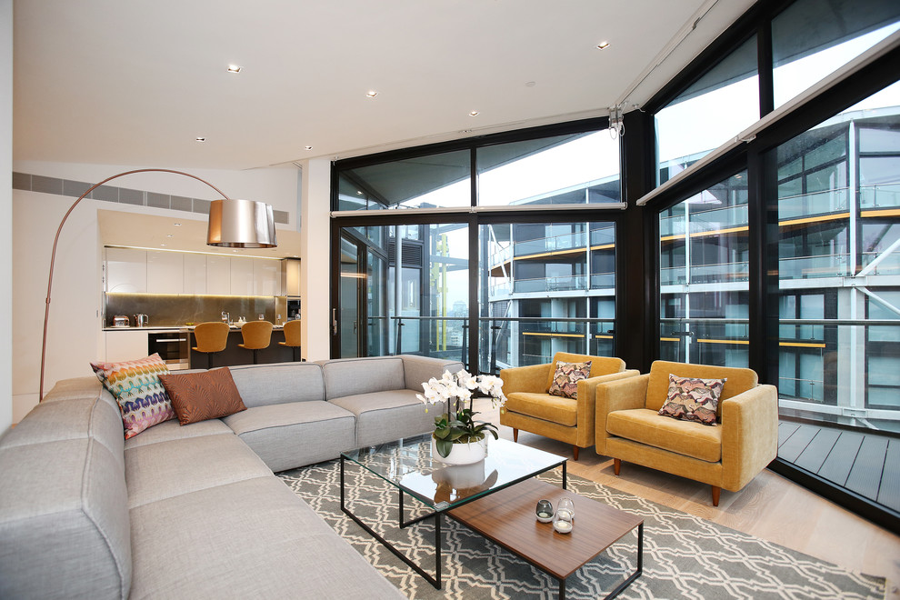 Contemporary living room in London with white walls and light hardwood floors.