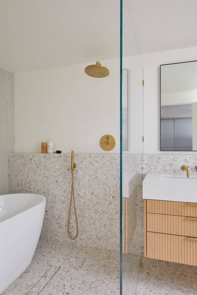 Small midcentury master bathroom in San Francisco with brown cabinets, a freestanding tub, a shower/bathtub combo, a wall-mount toilet, white tile, ceramic tile, white walls, terrazzo floors, an undermount sink, engineered quartz benchtops, white floor, an open shower, white benchtops, a double vanity and a floating vanity.