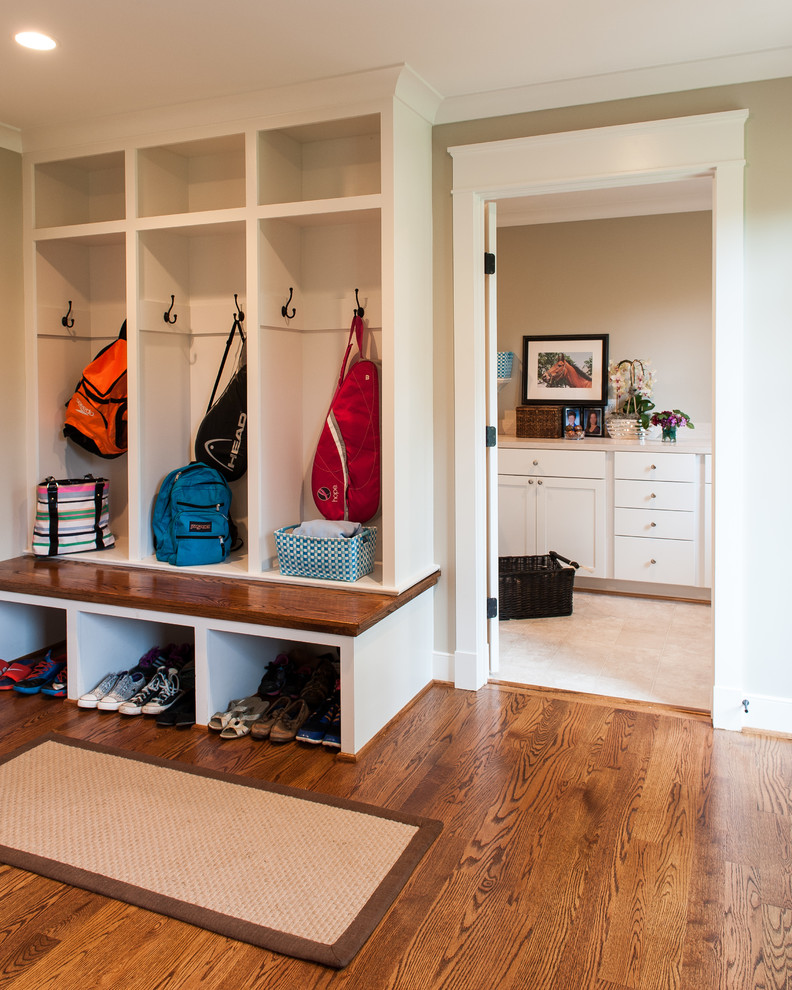 Design ideas for a large traditional mudroom in DC Metro with beige walls and dark hardwood floors.