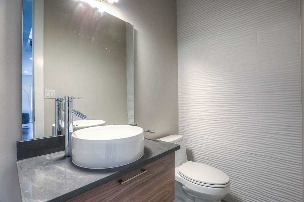 Design ideas for a small contemporary powder room in Houston with flat-panel cabinets, medium wood cabinets, a two-piece toilet, white tile, ceramic tile, grey walls, a vessel sink and concrete benchtops.