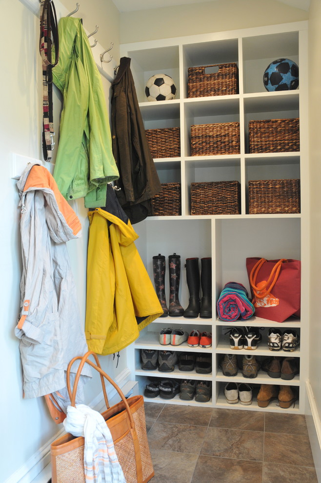 Design ideas for a mid-sized transitional mudroom in Boston with white walls, porcelain floors and brown floor.