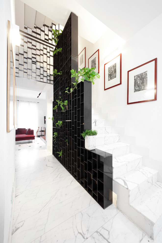 Expansive contemporary marble u-shaped staircase in Milan with marble risers.