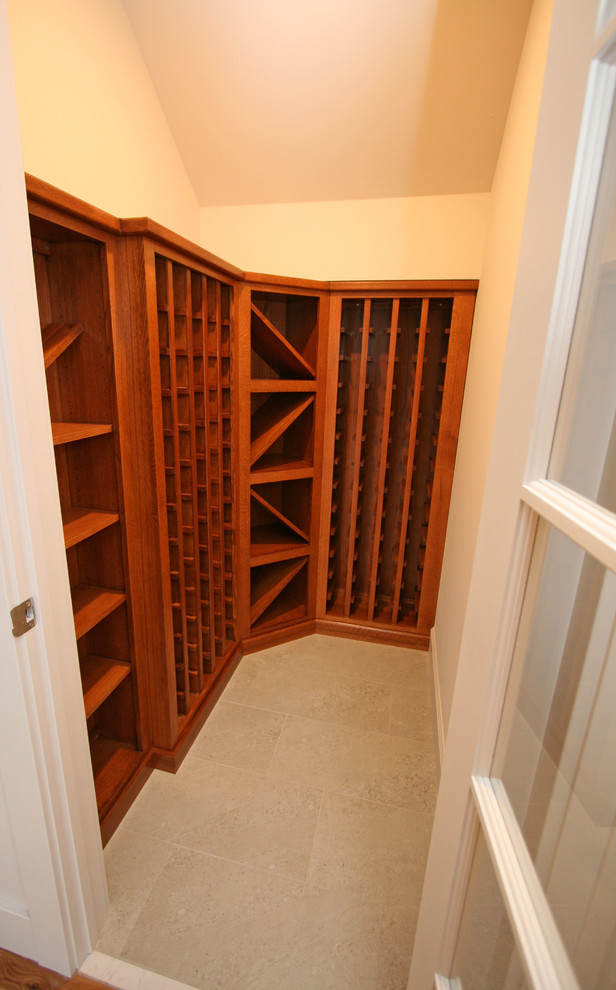 This is an example of a small traditional wine cellar in Seattle with porcelain floors and storage racks.