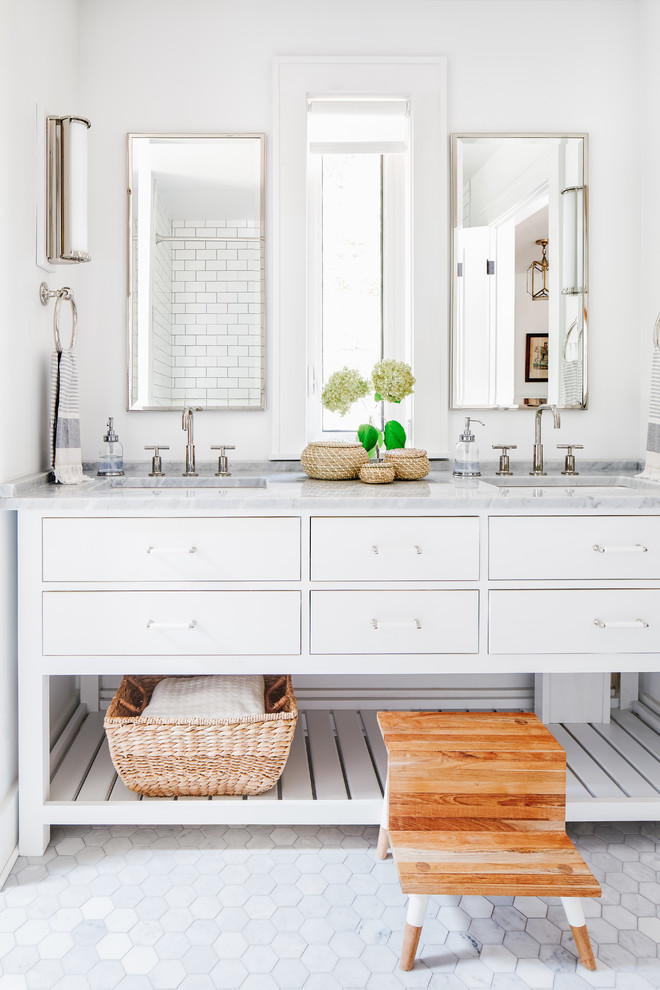 This is an example of a mid-sized beach style kids bathroom in Toronto with white cabinets, white walls, mosaic tile floors, an undermount sink, marble benchtops, grey floor, grey benchtops and flat-panel cabinets.