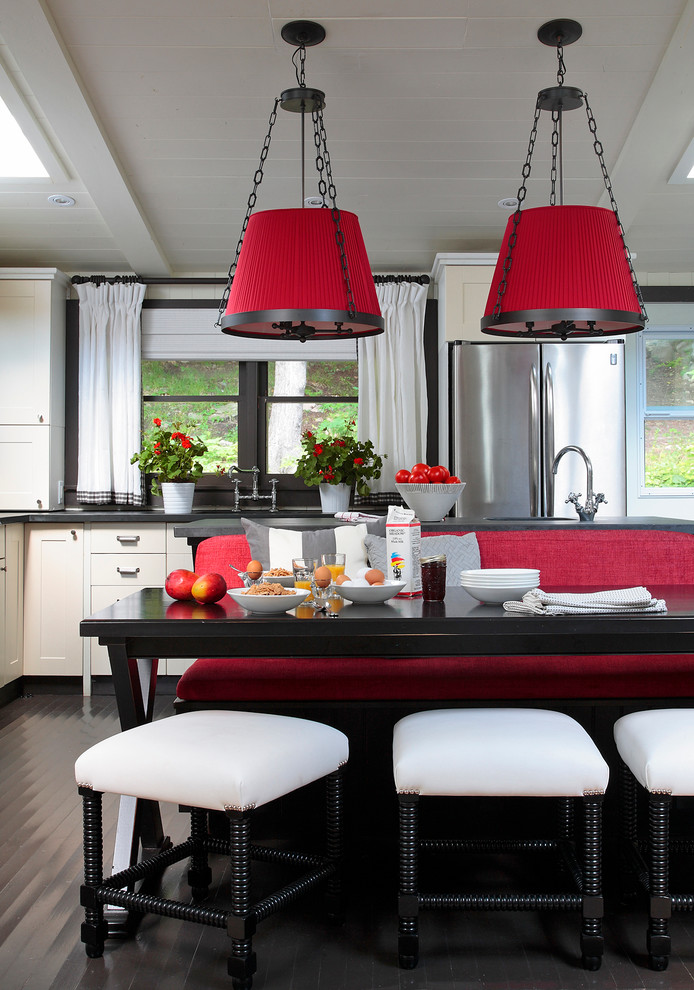Beach style kitchen in Other with shaker cabinets, white cabinets, stainless steel appliances and black floor.