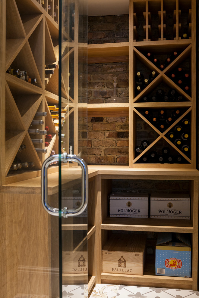 Mid-sized contemporary wine cellar in London with diamond bins.