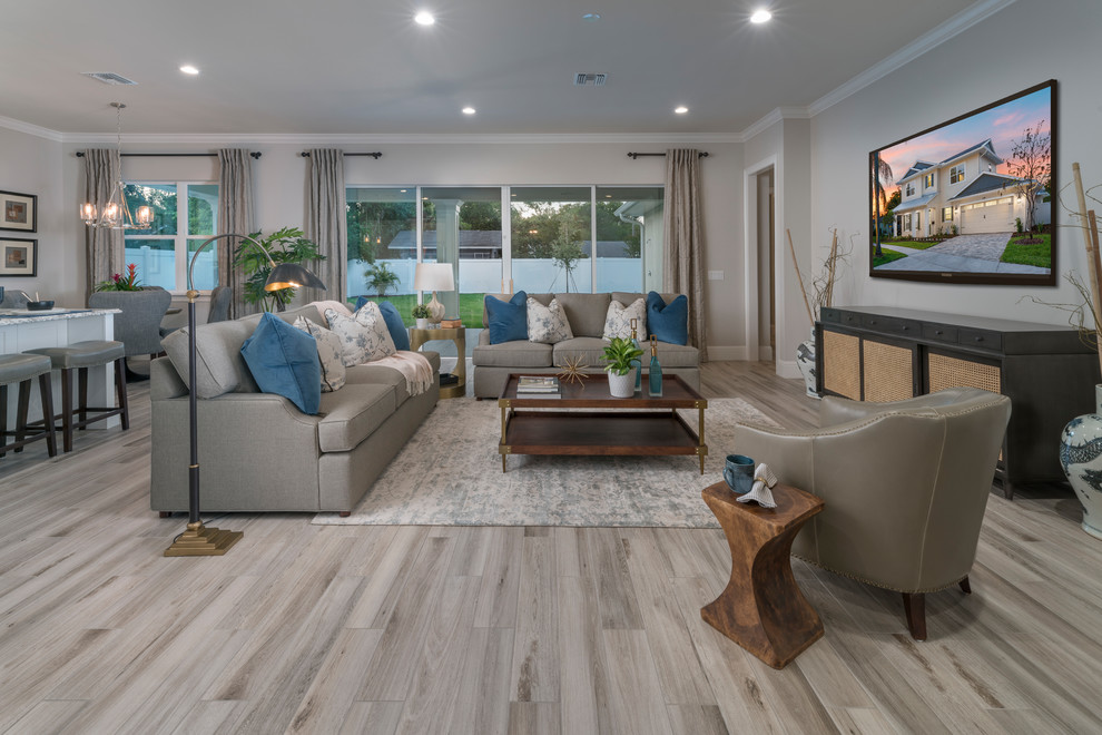 Mid-sized transitional open concept family room in Orlando with beige walls, porcelain floors, a wall-mounted tv and grey floor.