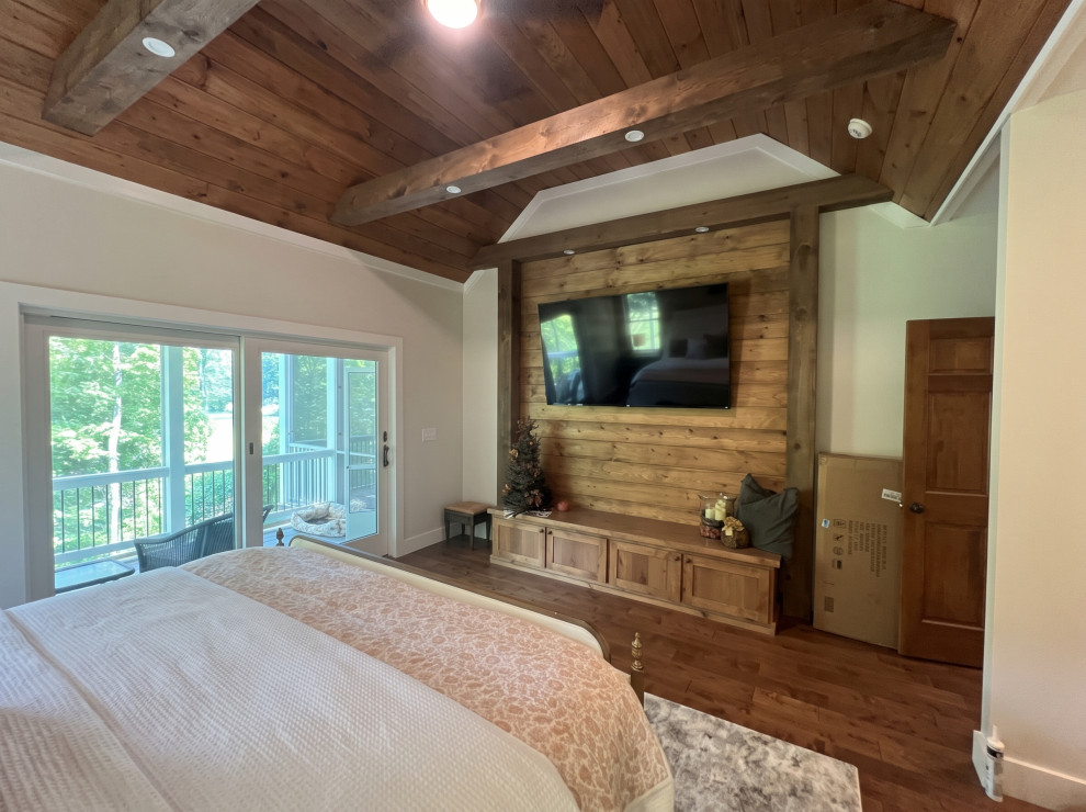 French Chalet Bedroom with Wood Accent Wall and Beams