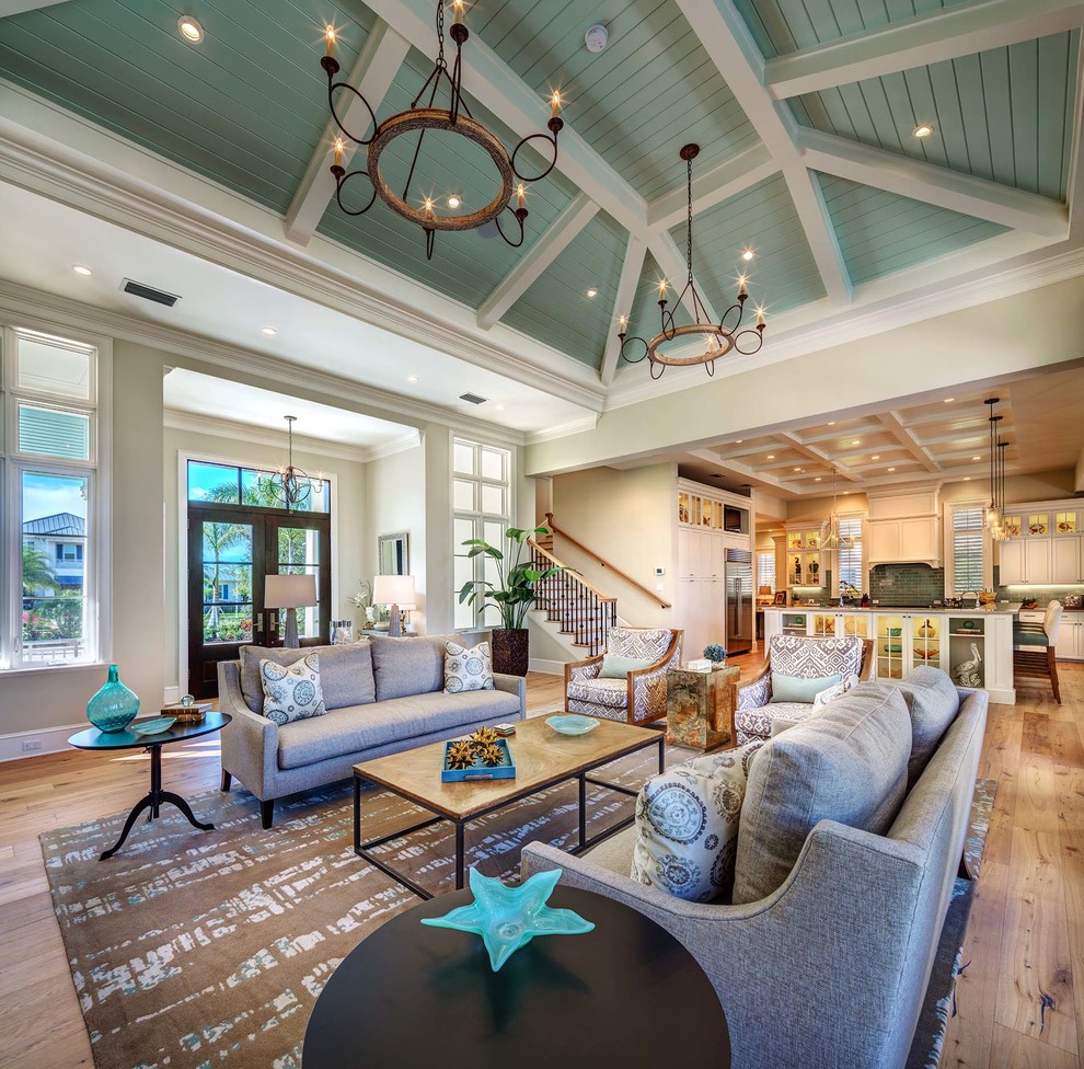 This is an example of a beach style formal open concept living room in Tampa with beige walls and light hardwood floors.