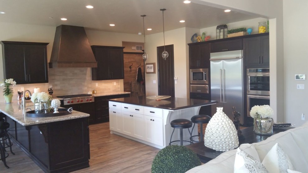 Inspiration for a large transitional u-shaped brown floor open concept kitchen remodel with an undermount sink, recessed-panel cabinets, dark wood cabinets, granite countertops, beige backsplash, porcelain backsplash, stainless steel appliances and an island