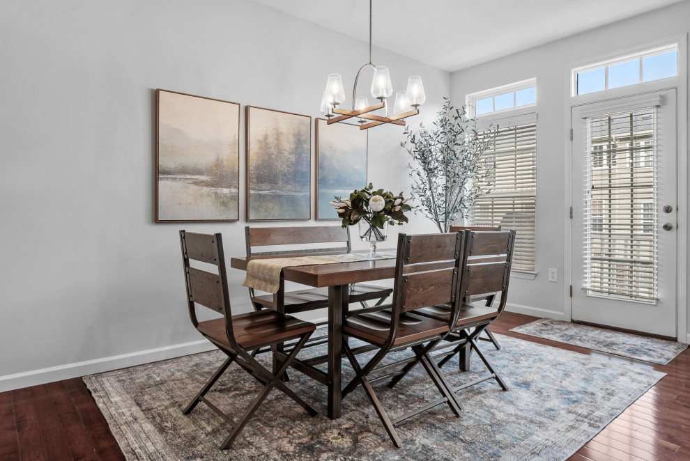 Inspiration for a transitional dark wood floor eat-in kitchen remodel with a double-bowl sink, gray cabinets, quartz countertops, stainless steel appliances, an island and white countertops