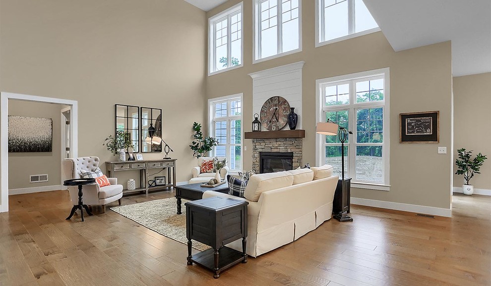 Expansive traditional open concept family room in Other with grey walls, light hardwood floors, a standard fireplace and a stone fireplace surround.