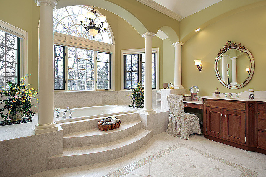 Inspiration for a large traditional master bathroom in New York with beaded inset cabinets, dark wood cabinets, an alcove tub, a two-piece toilet, beige tile, stone slab, beige walls, ceramic floors, an undermount sink, engineered quartz benchtops and beige floor.