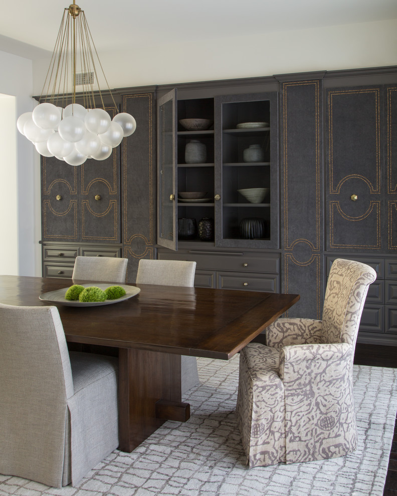 Transitional dining room in Los Angeles with white walls, dark hardwood floors and brown floor.