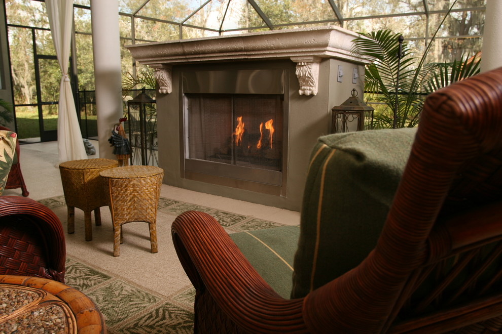 Inspiration for a mid-sized mediterranean sunroom in Tampa with a standard fireplace, a stone fireplace surround and a skylight.