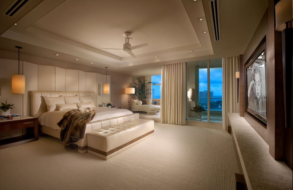 This is an example of a contemporary master bedroom in Miami with carpet, no fireplace and grey walls.
