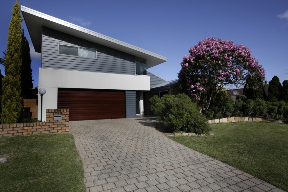 This is an example of a contemporary two-storey exterior in Newcastle - Maitland with mixed siding.