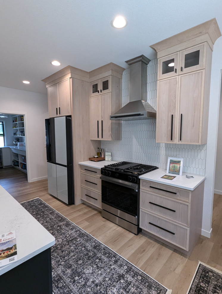 Inspiration for a large transitional l-shaped vinyl floor and brown floor eat-in kitchen remodel with a double-bowl sink, shaker cabinets, light wood cabinets, quartzite countertops, white backsplash, ceramic backsplash, stainless steel appliances, an island and white countertops