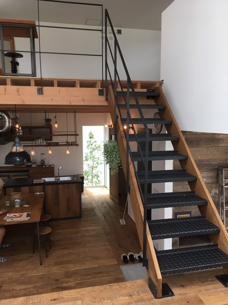 This is an example of a small industrial straight staircase in Other with open risers and metal railing.