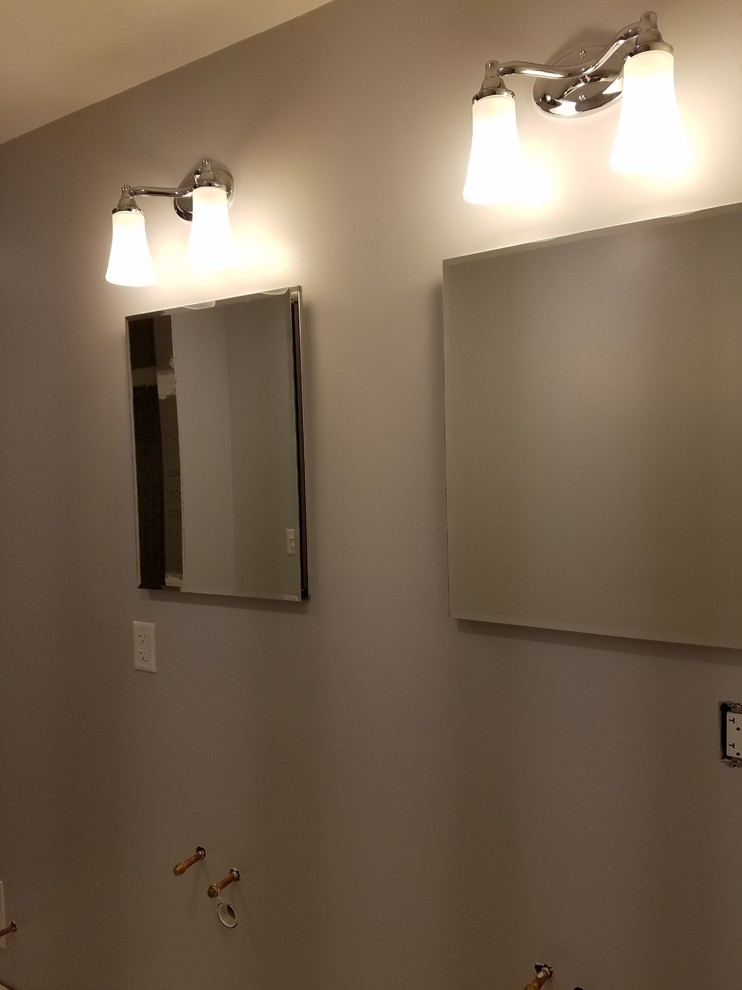 Example of a small transitional 3/4 blue tile and glass tile porcelain tile alcove shower design in Cincinnati with recessed-panel cabinets, black cabinets, a two-piece toilet, gray walls, an undermount sink and quartz countertops