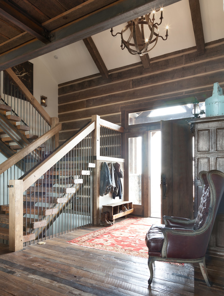 Inspiration for a large country foyer in Denver with white walls, dark hardwood floors, a single front door and a dark wood front door.