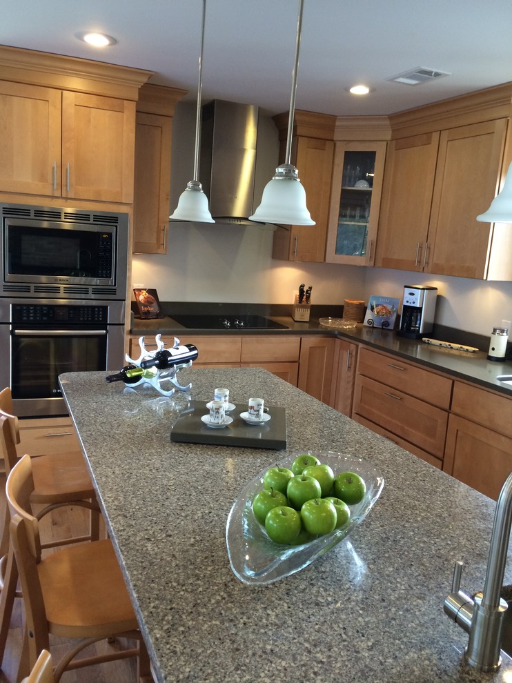 Inspiration for a mid-sized transitional u-shaped light wood floor open concept kitchen remodel with an undermount sink, shaker cabinets, light wood cabinets, quartz countertops, stainless steel appliances and an island