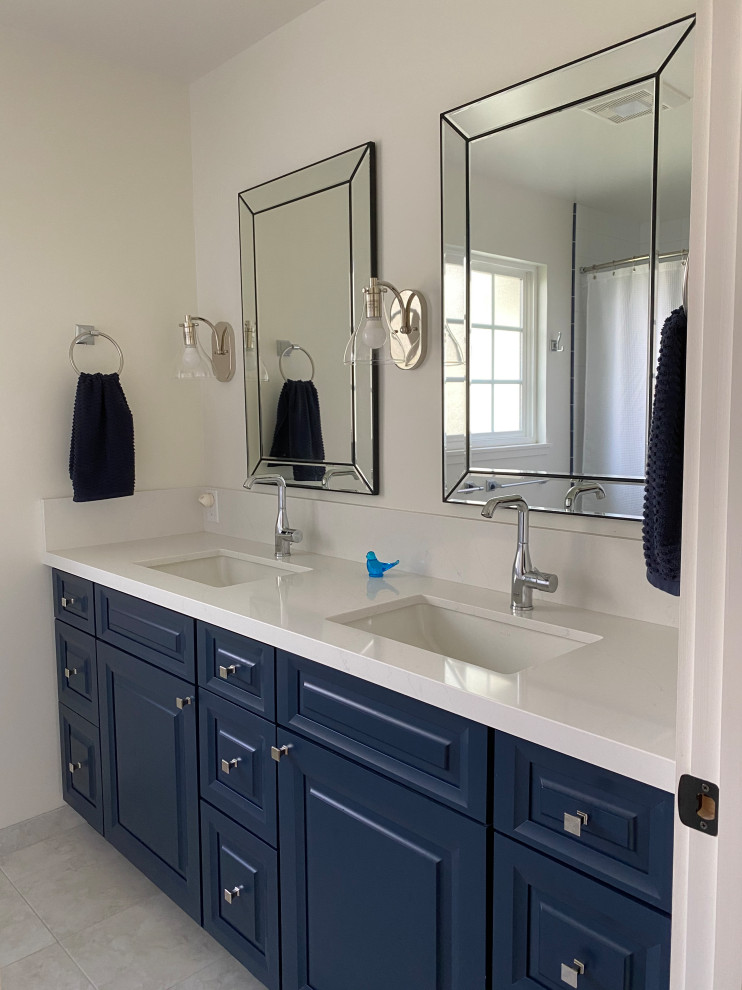 Bathroom - mid-sized cottage kids' white tile and porcelain tile double-sink bathroom idea in San Francisco with raised-panel cabinets, blue cabinets, an undermount sink, quartz countertops, white countertops and a built-in vanity