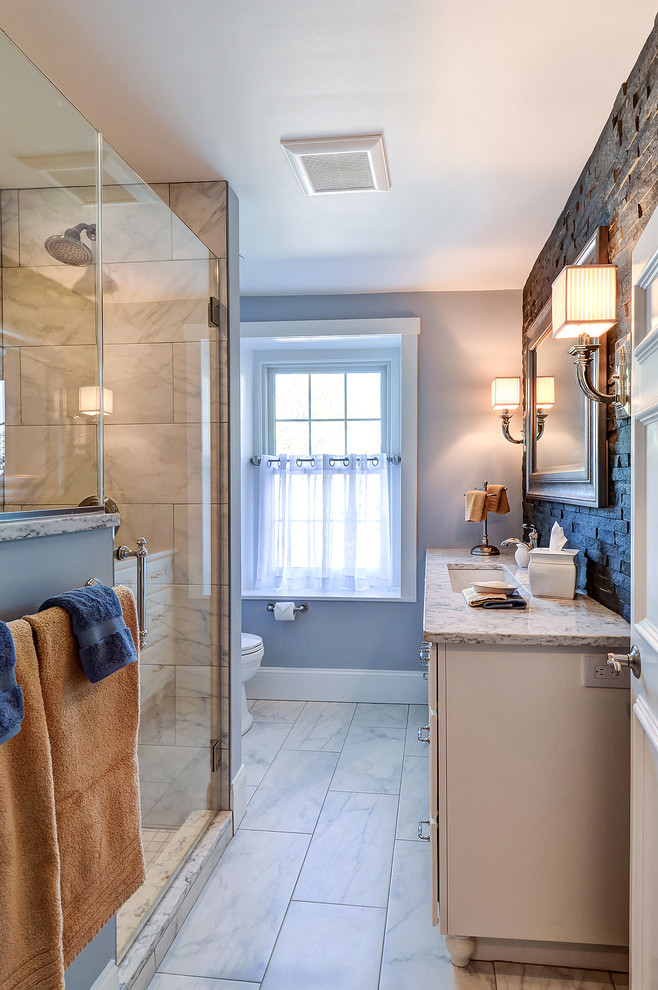 Photo of a mid-sized transitional 3/4 bathroom in Philadelphia with recessed-panel cabinets, white cabinets, an alcove shower, a two-piece toilet, gray tile, porcelain tile, grey walls, porcelain floors, an undermount sink and engineered quartz benchtops.