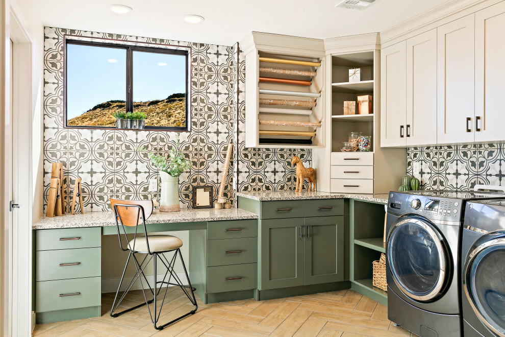 Modern u-shaped utility room in Salt Lake City with an undermount sink, shaker cabinets, green cabinets, granite benchtops, beige walls, porcelain floors, a side-by-side washer and dryer, brown floor and multi-coloured benchtop.