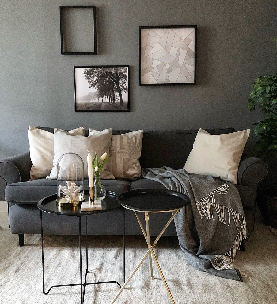 Photo of a small scandinavian open concept living room in Stockholm with grey walls, light hardwood floors, a wall-mounted tv and beige floor.