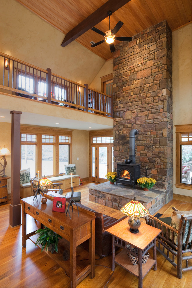 Mid-sized traditional formal open concept living room in Other with beige walls, light hardwood floors, a wood stove and a metal fireplace surround.