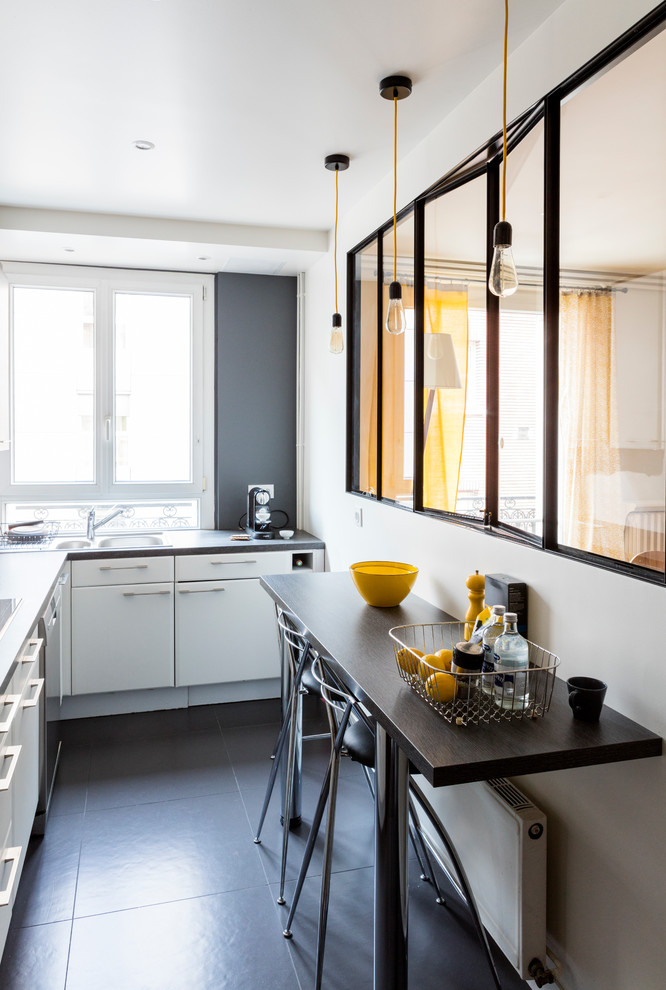 Photo of a small contemporary l-shaped eat-in kitchen in Paris with a double-bowl sink, flat-panel cabinets, white cabinets and no island.