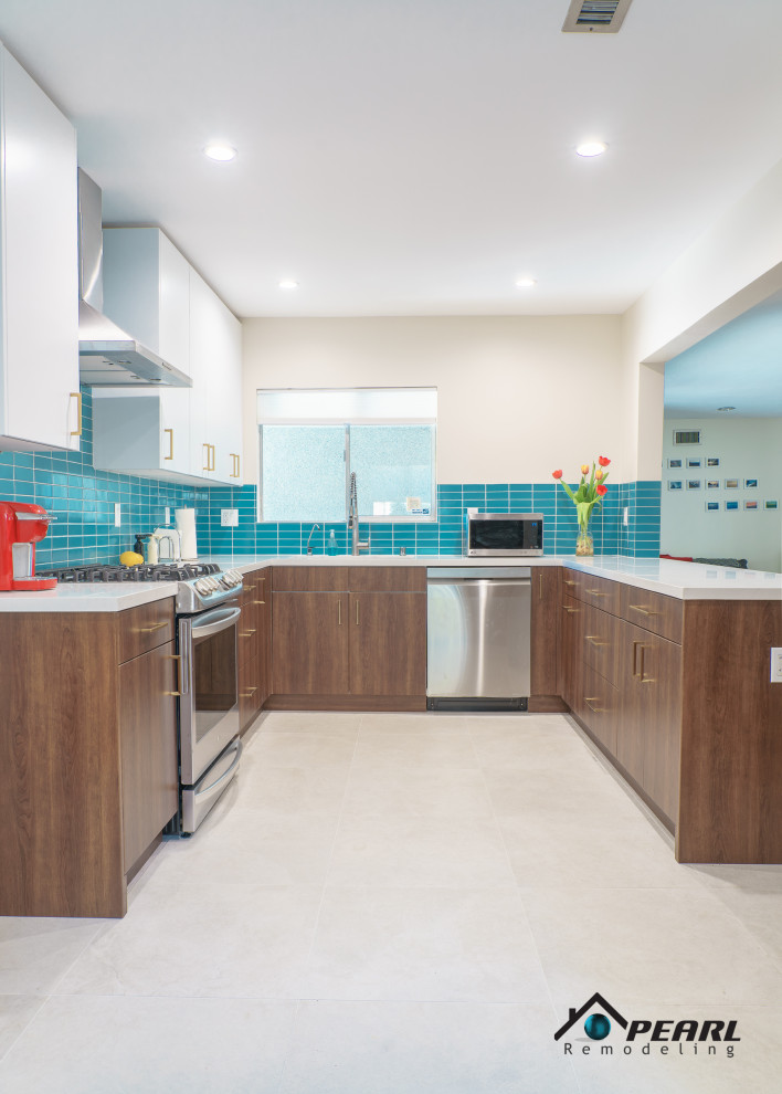 Inspiration for a large midcentury u-shaped kitchen pantry in Los Angeles with a built-in sink, flat-panel cabinets, dark wood cabinets, quartz worktops, blue splashback, metro tiled splashback, stainless steel appliances, ceramic flooring, a breakfast bar, beige floors and white worktops.