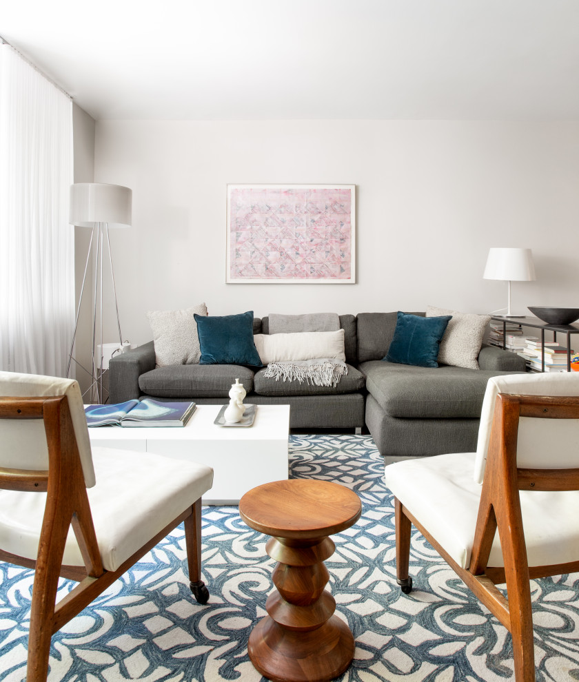 Imagen de sala de estar abierta minimalista pequeña con paredes blancas, suelo de madera en tonos medios y suelo blanco