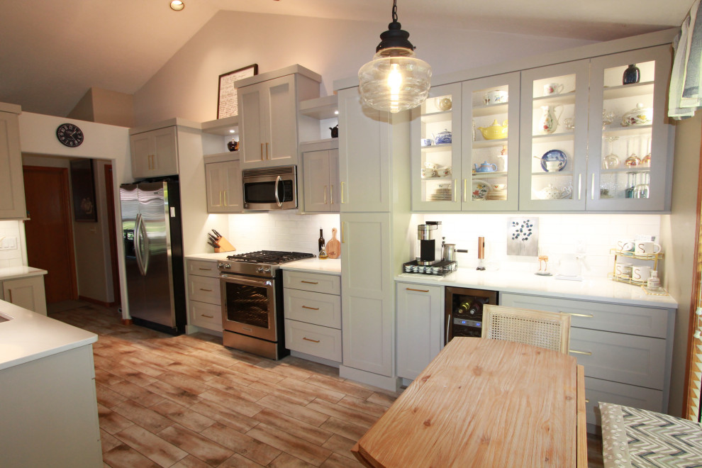 Mid-sized transitional kitchen photo with shaker cabinets, gray cabinets, quartzite countertops, subway tile backsplash, stainless steel appliances, no island and white countertops