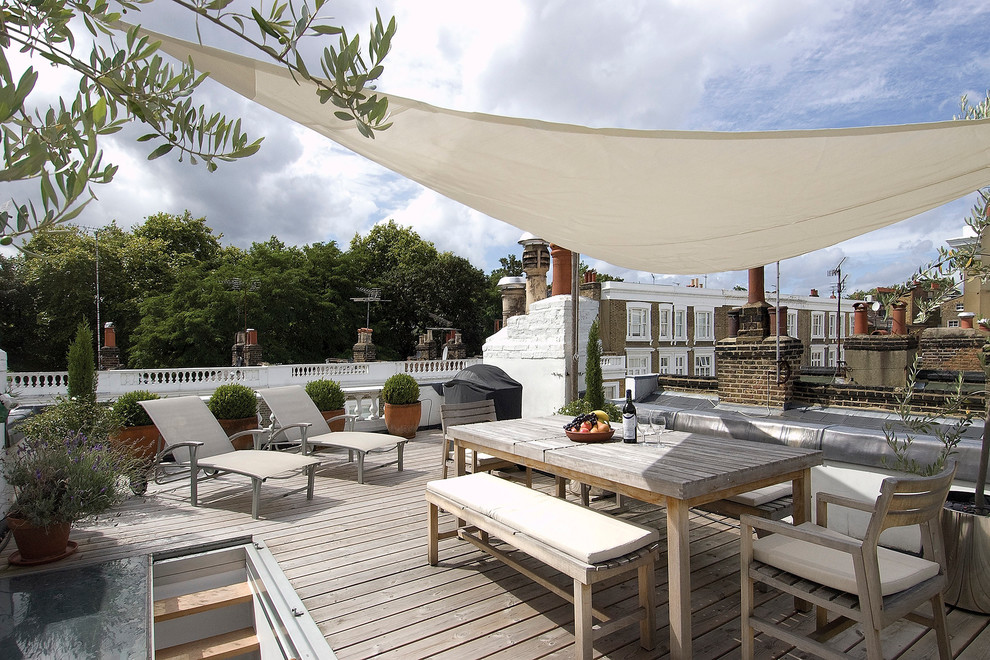 Design ideas for a large contemporary rooftop and rooftop deck in London with a container garden and an awning.