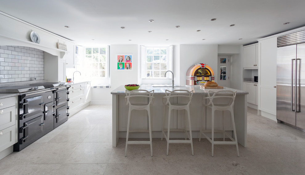 Photo of a large contemporary eat-in kitchen in Other with a farmhouse sink, shaker cabinets, white cabinets, quartzite benchtops, white splashback, ceramic splashback, stainless steel appliances, limestone floors, with island, grey floor and white benchtop.