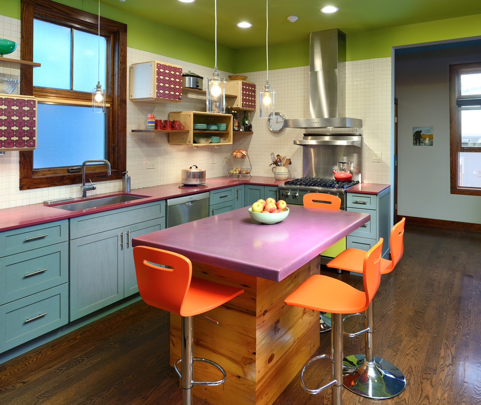 Eclectic l-shaped kitchen in Chicago with an undermount sink, shaker cabinets, blue cabinets, white splashback, stainless steel appliances, dark hardwood floors, with island and purple benchtop.