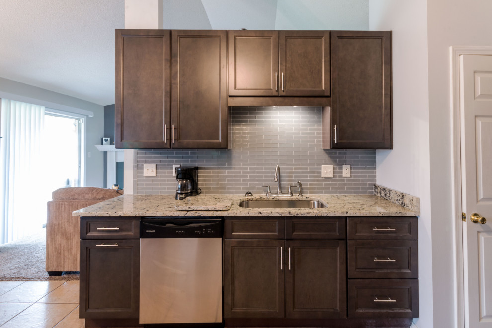 Eat-in kitchen - small galley cement tile floor and beige floor eat-in kitchen idea with an undermount sink, flat-panel cabinets, gray cabinets, granite countertops, gray backsplash, glass tile backsplash, stainless steel appliances, no island and white countertops