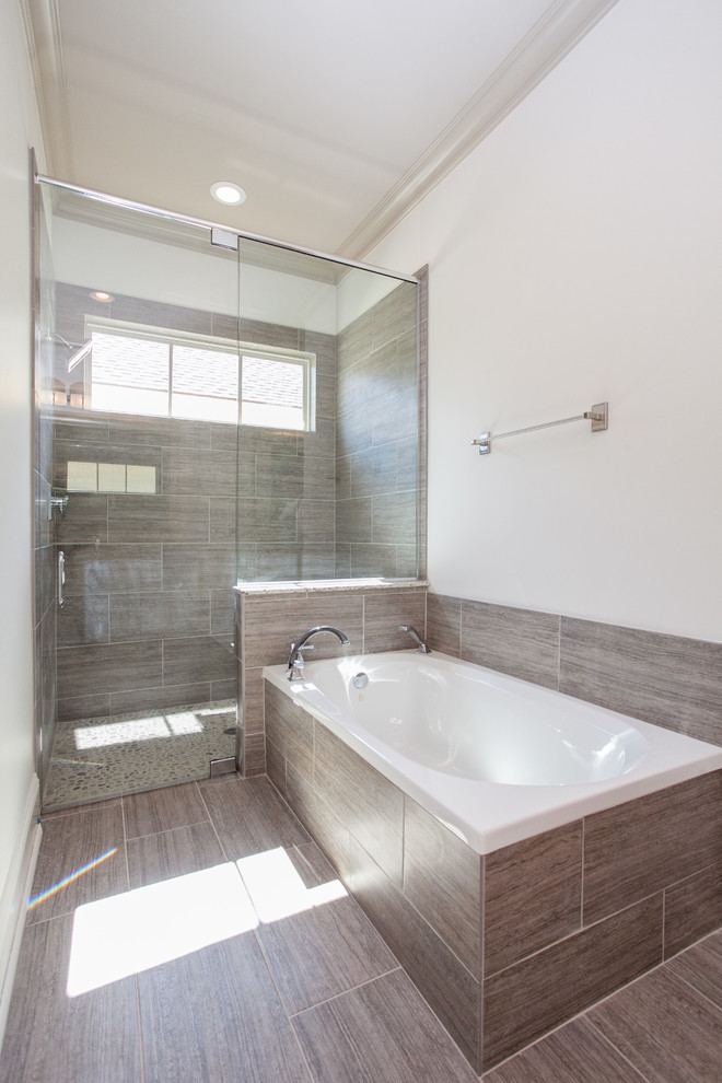 This is an example of a mid-sized transitional master bathroom in New Orleans with an alcove tub, a corner shower, brown tile, ceramic tile and light hardwood floors.