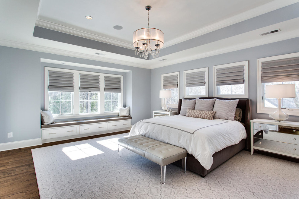 Photo of a large transitional bedroom in Atlanta with blue walls and dark hardwood floors.