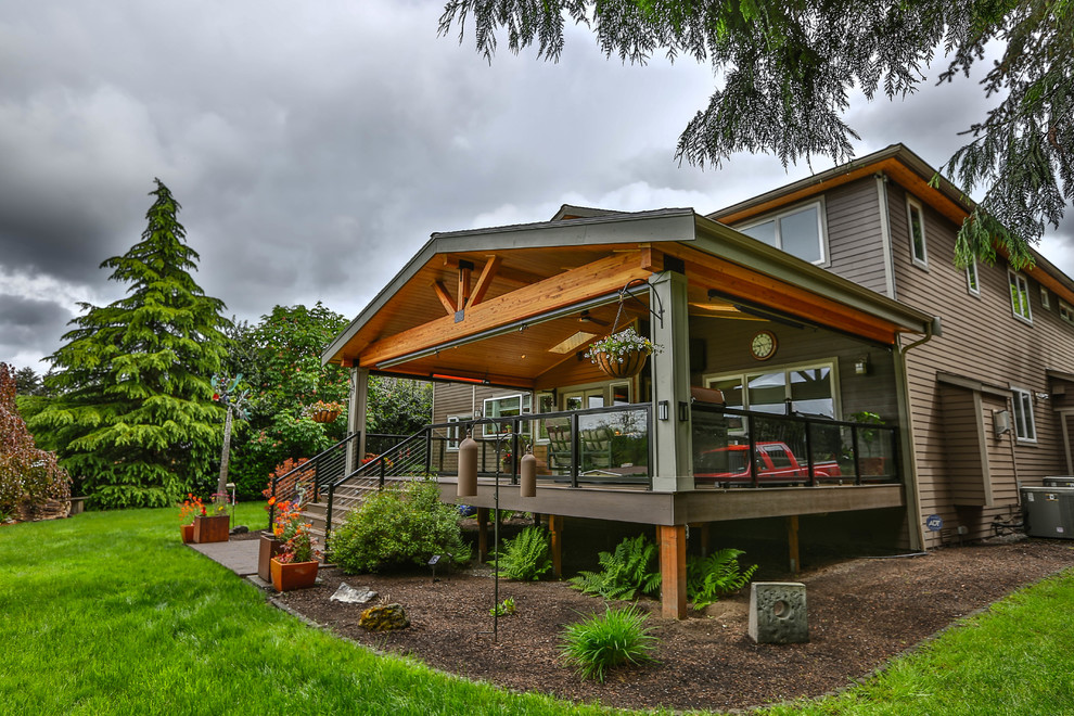 Inspiration for a large modern backyard deck in Seattle with an outdoor kitchen and a roof extension.