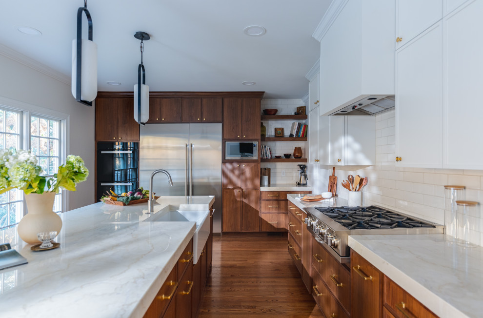 Inspiration for a large transitional eat-in kitchen remodel in DC Metro with medium tone wood cabinets, marble countertops and an island