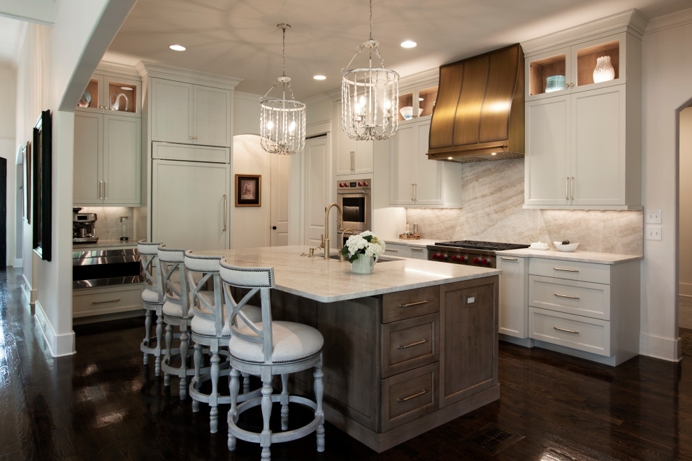 Inspiration for a large transitional l-shaped dark wood floor and brown floor open concept kitchen remodel in Nashville with an undermount sink, beaded inset cabinets, white cabinets, quartzite countertops, beige backsplash, stone slab backsplash, stainless steel appliances, an island and beige countertops