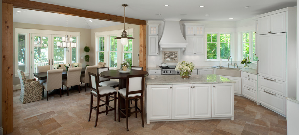 Photo of a traditional l-shaped eat-in kitchen in Grand Rapids with raised-panel cabinets, white cabinets, a farmhouse sink and panelled appliances.