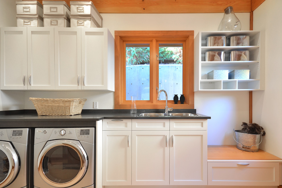 Traditional laundry room in Vancouver with a drop-in sink, shaker cabinets, white cabinets, white walls, a side-by-side washer and dryer and grey benchtop.